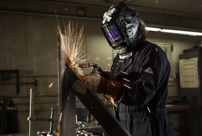 image of a arc welder wearing Flame Resistant Clothing