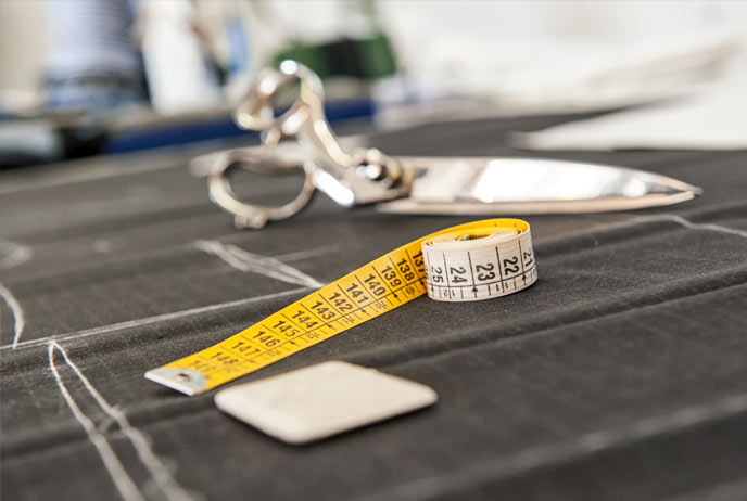 Image of scissors, measuring tape on cutting board