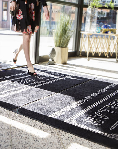 woman walking on entrance mat