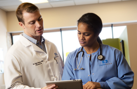 Image of two doctors in healthcare uniforms