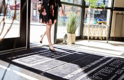 Woman walking on lobby mat