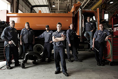 image of auto workers in front of a truck