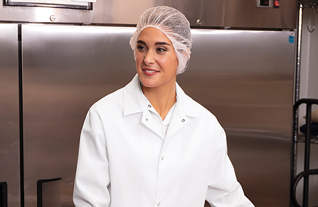 Image of woman in food processing uniform working